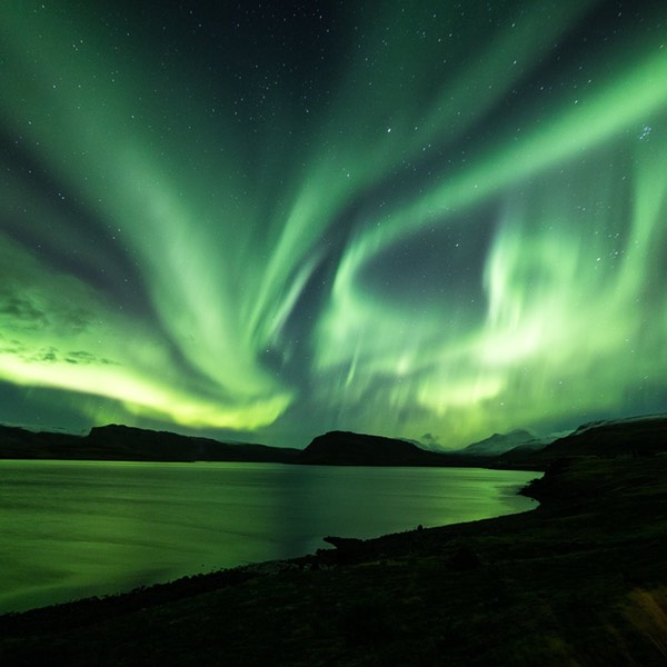 a-full-show-of-the-aurora-borealis-over-waters-in-iceland-1